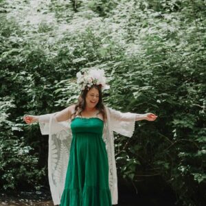 Woman dancing by a river having overcome anxiety and shame using EFT Tapping