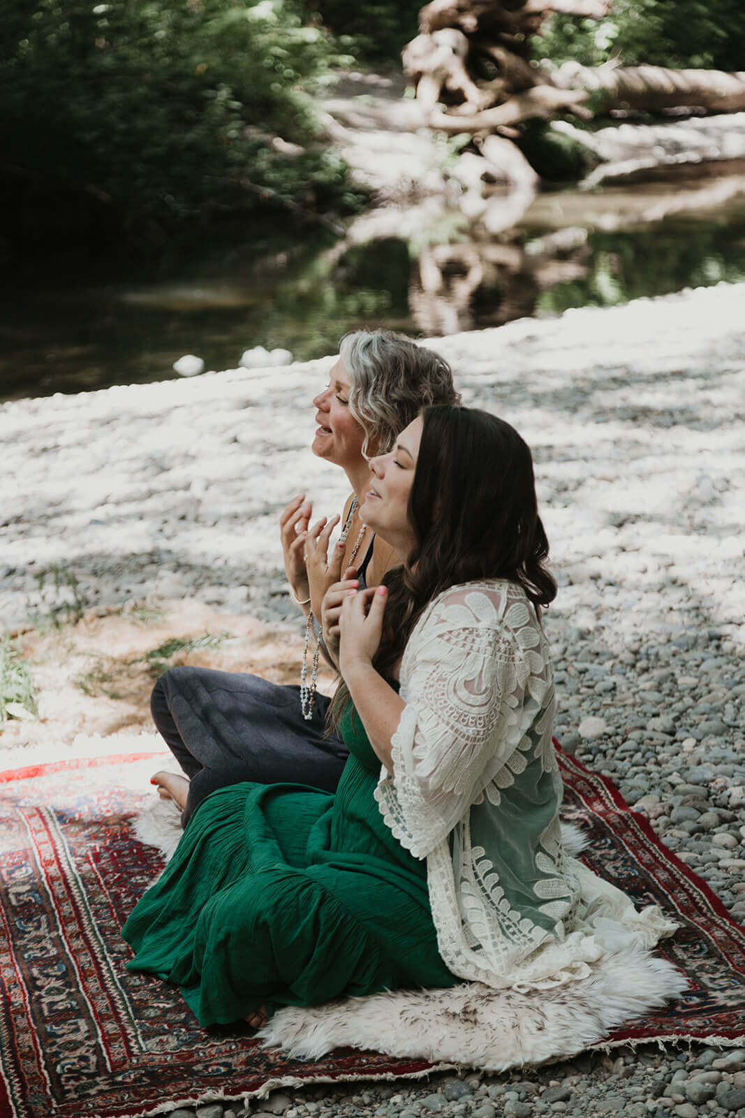 Two women sitting in a park tapping on shame and anxiety.